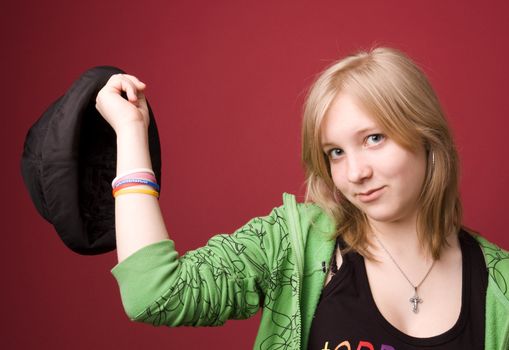 The young girl in green clothes on a red background.