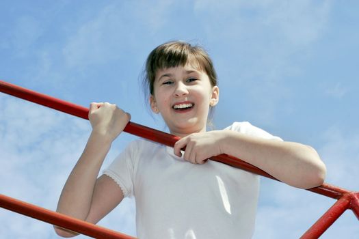 Smiling girl 11 years go up on sky background