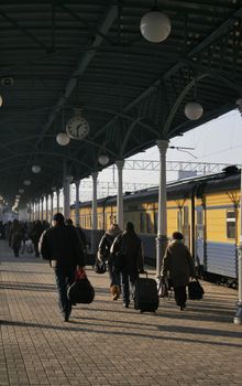 Many passengers on station beside train