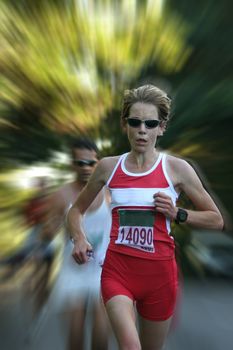 Artistic blur of a female athlete running fast