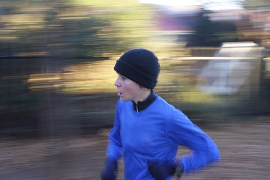 Artistic blur of a female athlete running fast