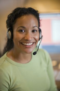 Smiling African American woman with earphones and microphone