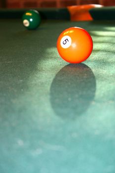 Backlit orange solid five ball in billiards or pool