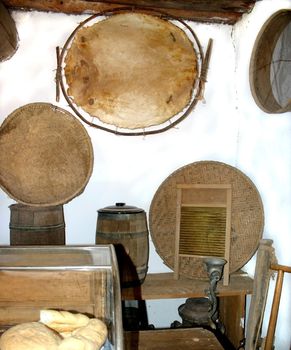 Detail of kitchen in centuries old hacienda, showing table washboard, barrels, and various baskets 