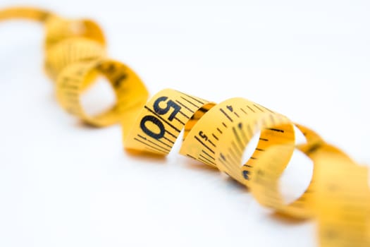 Close-up view of a measure tape isolated on white