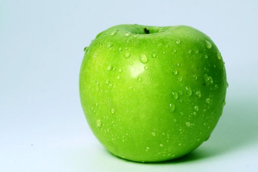 green fresh apple and waterdrops from it