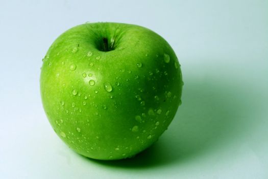 green fresh apple and waterdrops from it