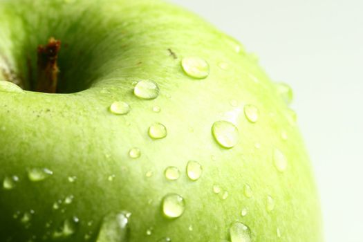 green fresh apple and waterdrops from it