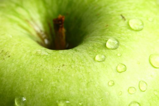 green fresh apple and waterdrops from it