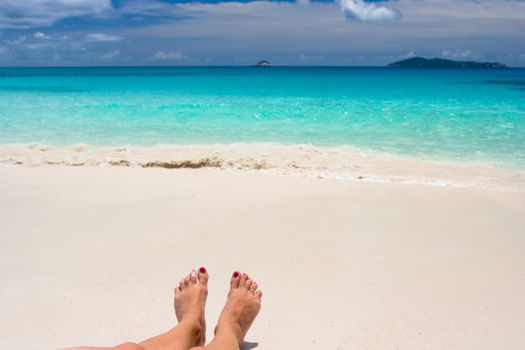 feets on white beach