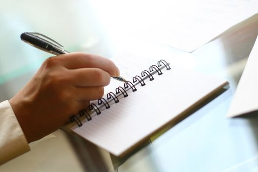 businessman hand write message in note 