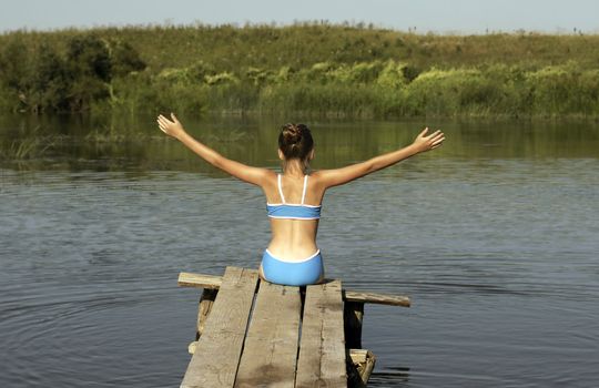 The Girl sit on boards over river