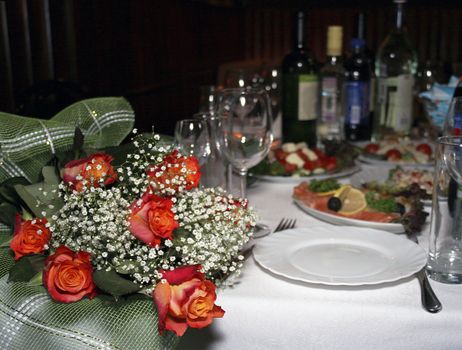 Bouquet of the red roses on table for guests