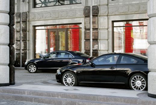 Two modern cars business-class are parked beside calve