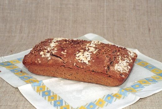 A loaf of rye bread on dish-cloth
