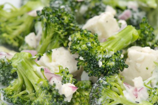 Macro of a broccoli and feta salad with shallots