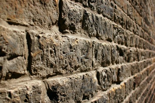 A perspective shot of a stone wall (shallow DOF).