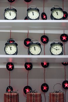 Several alarm clocks on bookshelf in shop