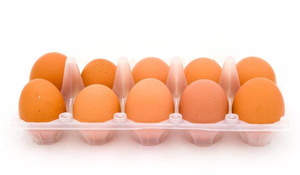 Ten eggs in packing on a white background