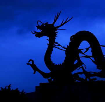 A statue of an Asian dragon at dusk. Photo is from Pusan, South Korea.