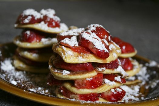 A picture of pancakes with strawberry.