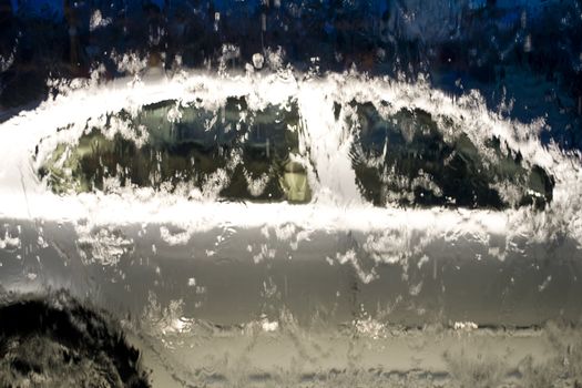 Car behind glass window with water in shopping mall