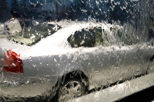 Car behind glass window with water in shopping mall