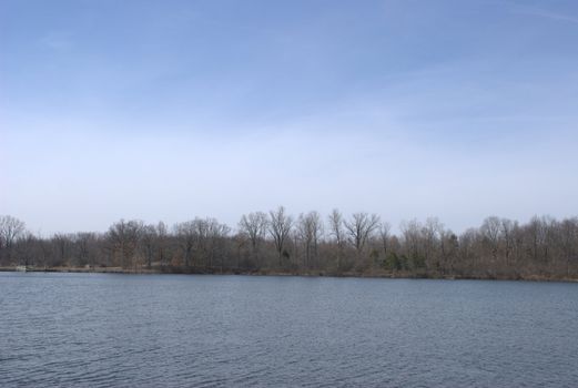 A lake landscape showing the far shore across the water.