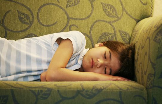 Little girl  asleep on couch