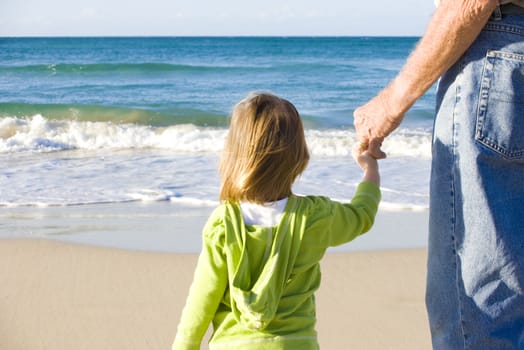 
young girl at the beach with her grandfather