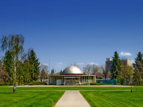 A modern domed building abandoned and fenced off in Edmonton, Alberta, Canada.