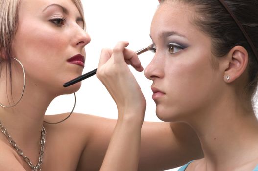 Professional make up artist applying make up on a teen model