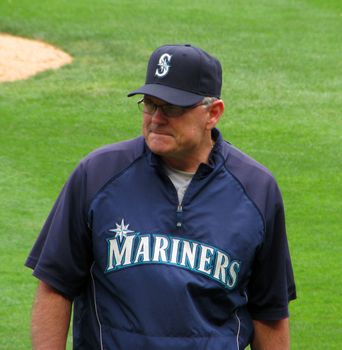 Seattle Mariner baseball coach walks to the dugout.
