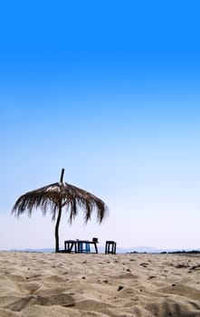 Tropical sandy beach with hut on a sunny day