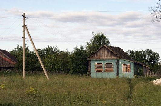 The Abandoned old house with closed window. Summer. Russia