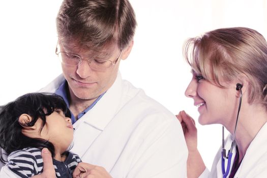 Two kind and friendly  doctors caring for scared child patient