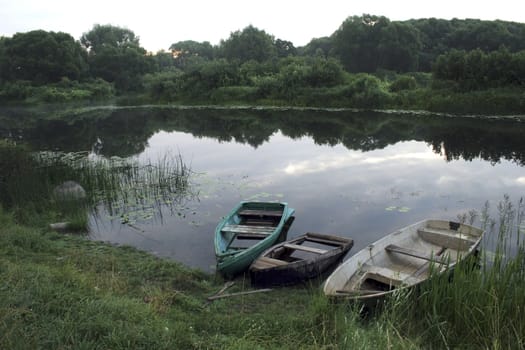 three riverside boats by summer