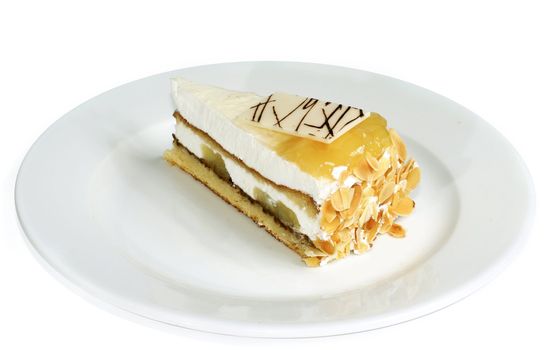 peach cake with segment of chocolate and bit of the almond nut