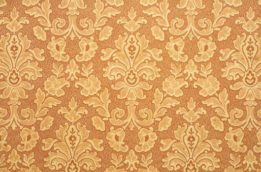 Floral vintage wallpaper background. Old Yellowed orange color.
