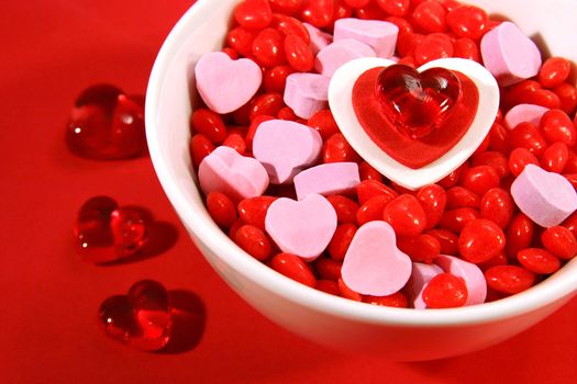 An assortment of Valentine candies in a white bowl