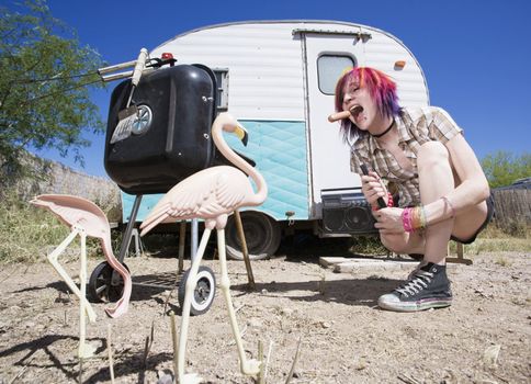 Girl in front of a trailer with a hotdog and a barbecue