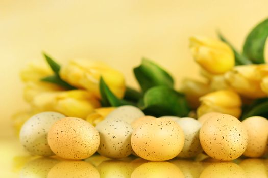 Easter eggs and tulips laying on counter