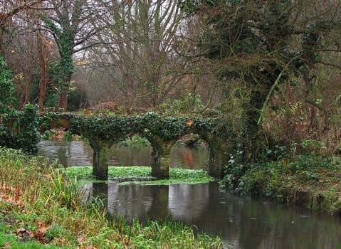 Bridge in park during January rain in England