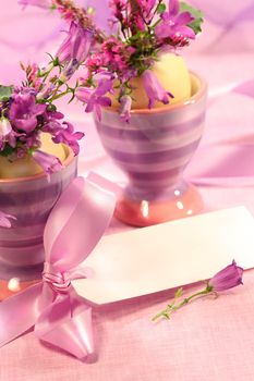 Purple flowers in eggs cups for Easter