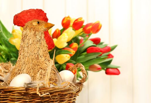 Straw chicken in wicker basket with eggs 