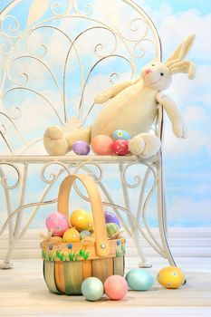 Easter bunny with eggs on garden chair