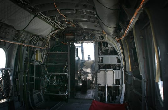 The inside of a transport helicopter with the few to the front.