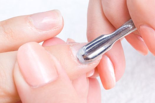 manicure applying - cleaning the cuticles 