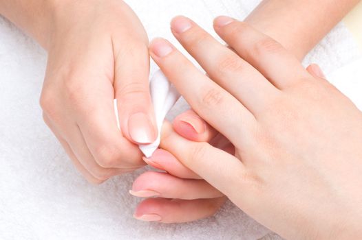 manicure applying - wiping the mosturizer from end of fingers