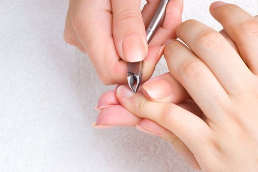 nail salon - cuticle cut on the female little finger